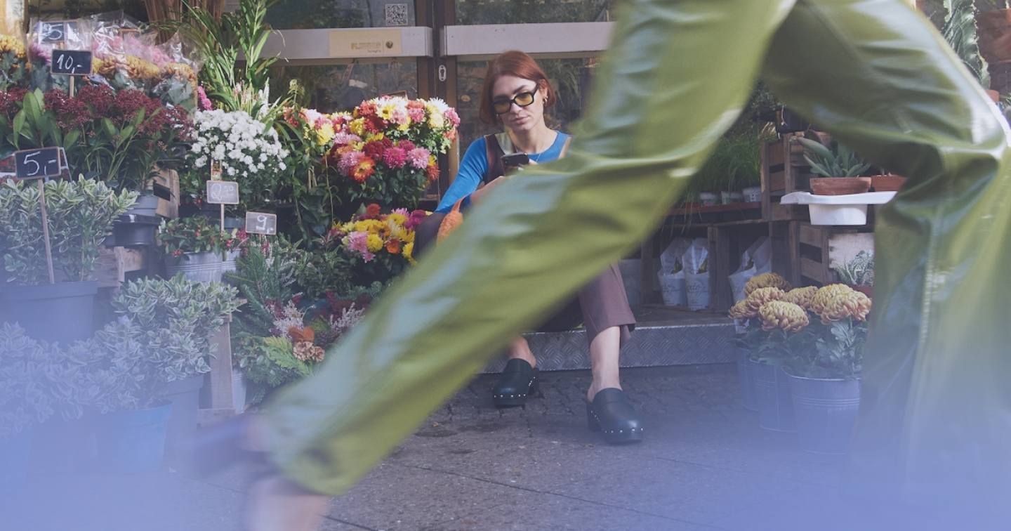 woman walking in front of flower shop